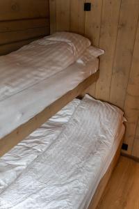 two bunk beds in a room with wooden walls at Jutulhytta 