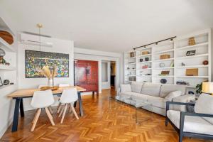 a living room with a couch and a table and chairs at Mar de fondo en Pedregalejo in Málaga +30 photos