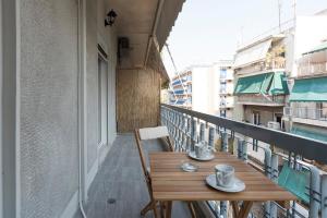 a wooden table on the balcony of a building at Central apartment 3' to Metaksourgio metro station in Athens