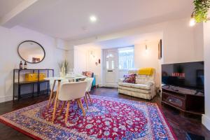 a living room with a table and a tv at Palmyra Square by Tŷ SA in Newport