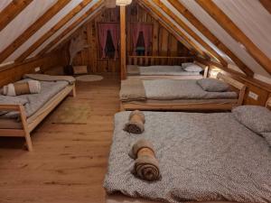 a room with three beds in a attic at Ruralna kuća za odmor Brezanka in Gornja Stubica