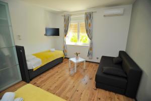 a small room with a bed and a couch at Emily Ap in Split