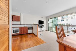 a kitchen with a table and a counter top at Metro Retreat - Auckland Central Apartment in Auckland