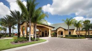 a house with palm trees in the driveway at Top Villas - Paradise Palms Resort 277 in Kissimmee