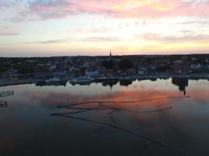 a view of a large body of water at sunset at Schleiblick App 6 in Rabenkirchen-Faulück +8 photos