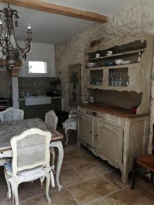 a kitchen with a table and a dining room at Mazet A l Ombre des Z ' oliviers in Port-Sainte-Foy-et-Ponchapt