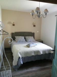 a bedroom with a bed with white blankets and pillows at Mazet A l Ombre des Z ' oliviers in Port-Sainte-Foy-et-Ponchapt