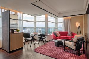 a living room with a red couch and a table at Hyatt Centric Zhongshan Park Shanghai in Shanghai