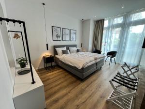 a bedroom with a bed and a table and chairs at Glashaus mit 3 Gästezimmer in Mettingen