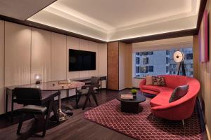 a living room with a red couch and a table at Hyatt Centric Zhongshan Park Shanghai in Shanghai