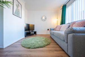 a living room with a couch and a rug at Rogerstone House by Tŷ SA in Rogerstone