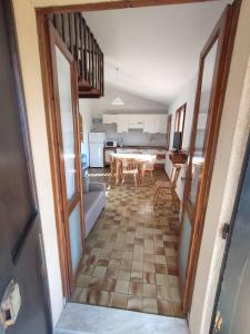 a view of a kitchen and dining room with a table at Anna e Ale - mare e relax in Costa Rei +17 photos