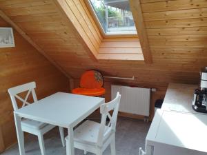 a table and chairs in a room with a attic at Holzhausidylle am Steimel in Neunkirchen