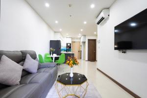 a living room with a couch and a table at Aparment Hà Đô Centrosa in Ho Chi Minh City