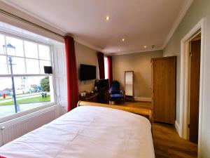 a bedroom with a bed and a large window at Min y Don Llandudno in Llandudno