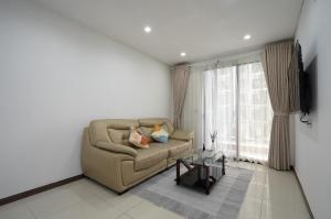 a living room with a couch and a table at Aparment Hà Đô Centrosa in Ho Chi Minh City