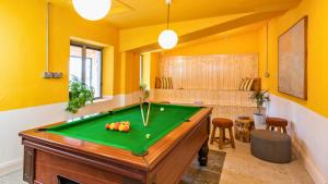 a pool table in a room with yellow walls at Killary Adventure Company in Leenaun