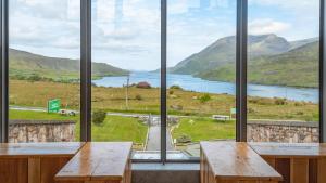 a room with a view of a lake and mountains at Killary Adventure Company in Leenaun