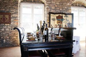 a table with plates and wine bottles and glasses at Hillside Villa over Lemonodasos in Galatas