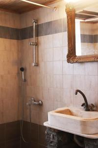 a bathroom with a sink and a mirror at Hillside Villa over Lemonodasos in Galatas +23 photos