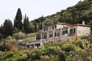 an old house on the side of a hill at Hillside Villa over Lemonodasos in Galatas