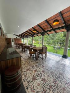 a patio with a table and chairs and a barrel at Coffee minas estate bungalow in Yercaud