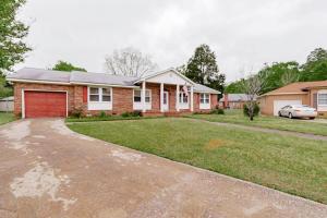 a brick house with a garage and a driveway at The Garnet Ranch Large Yard Near Jackson USC in Columbia
