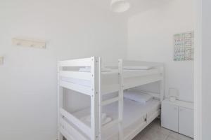 białe łóżko piętrowe w białym pokoju w obiekcie Stavros Hideaway w Chanii