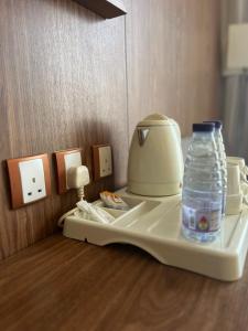 a bottle of water sitting on top of a tray at Manarat Gaza Hotel - Al Haram Tower in Mecca
