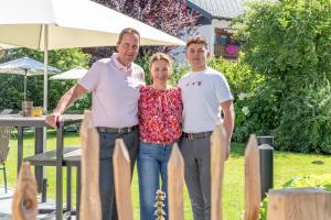 two men and a woman posing for a picture at Hotel Bergland All Inclusive Top Quality in Seefeld in Tirol