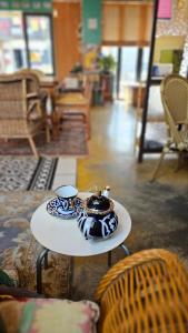 a table with a tea pot and aucer on it at Pedro's House - Foreigners only in Gwangju