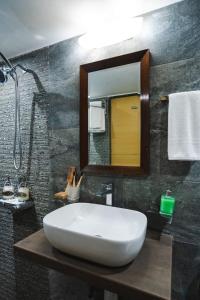 a bathroom with a white sink and a mirror at Villas By Hangout in Lonavala