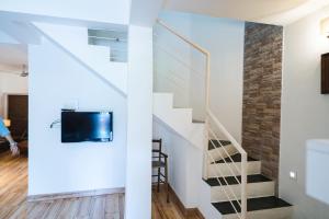 a staircase in a house with a glass wall at Villas By Hangout in Lonavala