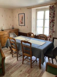 a dining room with a blue table and chairs at Le gîte de Rose in Pusy-et-Épenoux +21 photos