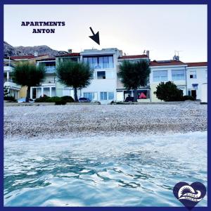 a view of a building from the water at Apartment Anton in Baška