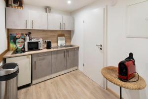 a kitchen with a counter with a microwave and a chair at Vogelsberger Bett 7 die 1 in Alsfeld