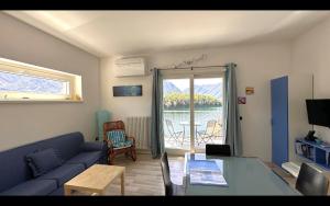 a living room with a couch and a table at Gardenia Apartment Ossuccio in Ossuccio