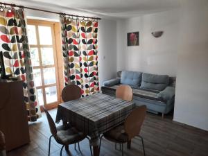 a living room with a couch and a table and chairs at Nosztalgia Vendégház in Bogács