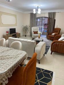 a living room with a couch and a table and chairs at Welcome home in Ma‘ān