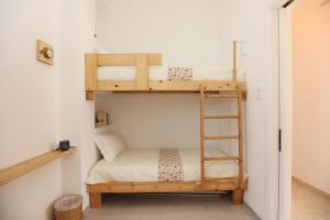 a bedroom with two bunk beds and a ladder at San Nikolas view guest house in Ermoupoli