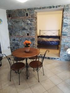 Zimmer mit einem Tisch, Stühlen und einem Bett in der Unterkunft BELLAVISTa in Casalvecchio Siculo