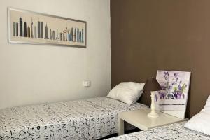 a bedroom with two beds and a table with a lamp at Lovely House in Sant Feliu in Sant Feliu de Guixols