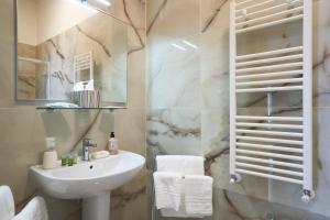 ein Bad mit einem Waschbecken und einem Spiegel in der Unterkunft Villa dei Poeti in La Spezia