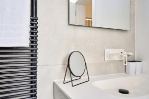 a bathroom with a mirror and a sink at Stylish Apartment in Tigne Point in Sliema +32 photos