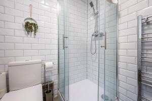 a bathroom with a glass shower with a toilet at Free Parking - The Coach House B by Tŷ SA in Cardiff