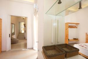 a room with a bed and a glass window at San Nikolas view guest house in Ermoupoli +32 photos