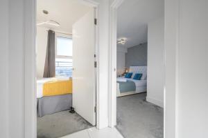 a bedroom with two beds and a window at Skyline, by Tŷ SA - Stay Central with Free Parking in Cardiff