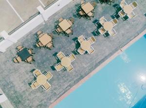 an overhead view of tables and chairs next to a pool at G-Pinnacle Signature in Ilorin