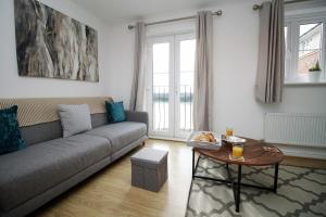 a living room with a couch and a table at Sleeps 6 - Argosy Way by Tŷ SA in Newport