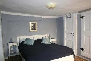 sypialnia z czarnym łóżkiem i niebieskimi ścianami w obiekcie Jendrik w mieście Lauterbach
